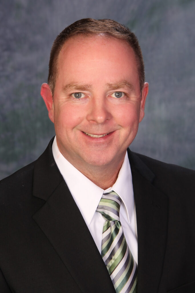 Professional photo of Dan Powell, Home watch Rochester, wearing a suit and tie.